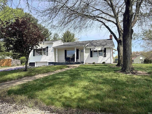 tri-level home with a porch, fence, a chimney, and a front lawn