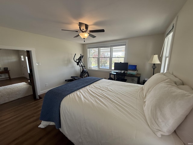 bedroom with baseboards, a ceiling fan, and dark wood-style flooring