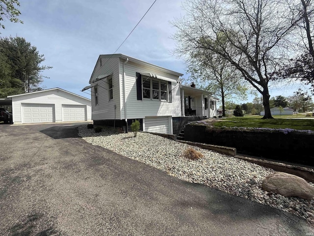 view of side of property featuring an outbuilding and a garage