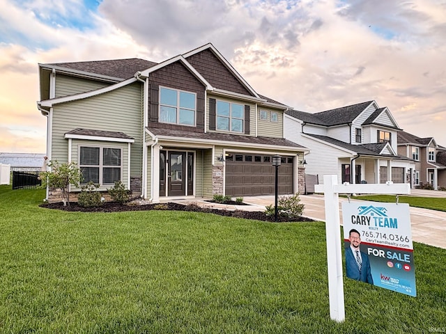 craftsman house with fence, an attached garage, stone siding, concrete driveway, and a lawn