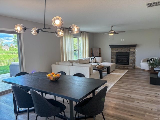 dining room featuring ceiling fan, visible vents, a wealth of natural light, and light wood-style flooring