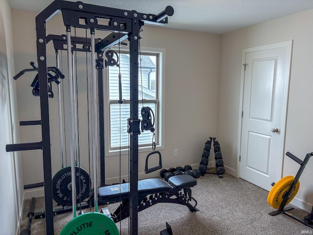 exercise room featuring carpet floors and baseboards