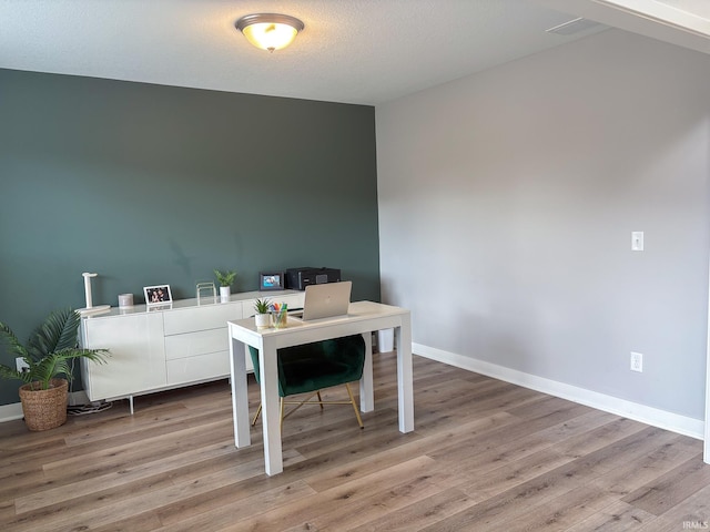 office area with baseboards and wood finished floors
