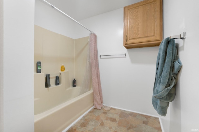 bathroom with baseboards and shower / bath combo