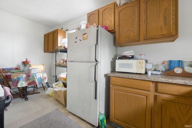 kitchen featuring brown cabinets and white appliances