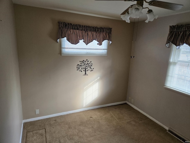 unfurnished room featuring baseboards, ceiling fan, carpet flooring, and visible vents