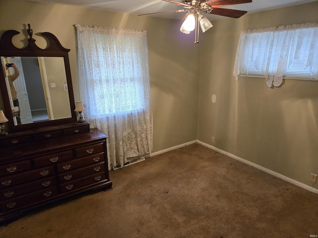 unfurnished bedroom featuring carpet flooring, a ceiling fan, and baseboards
