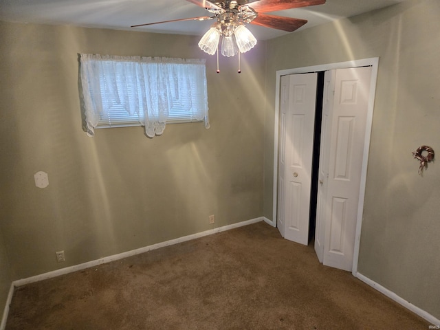 unfurnished bedroom featuring a ceiling fan, baseboards, carpet, and a closet