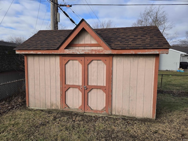 view of shed featuring fence