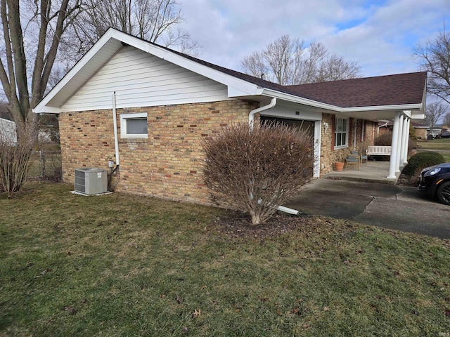 view of property exterior with brick siding, a garage, central AC, and a yard