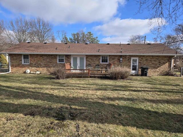 back of house with a lawn, a deck, and brick siding