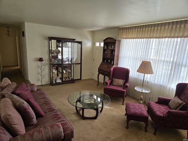 carpeted living room featuring baseboards