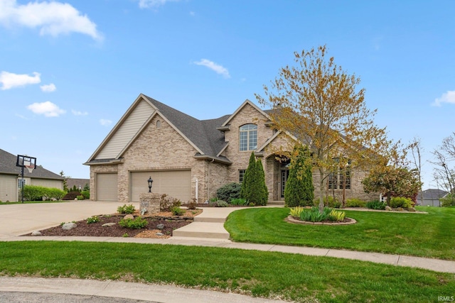 1206 Phaeton Way, Auburn, IN 46706 - view of front of home featuring a garage, concrete driveway, brick siding, and a front yard