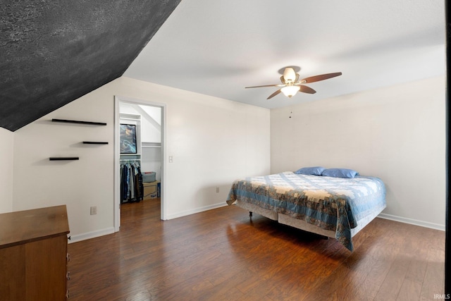 1206 Phaeton Way, Auburn, IN 46706 - bedroom with ceiling fan, a walk in closet, baseboards, and wood finished floors