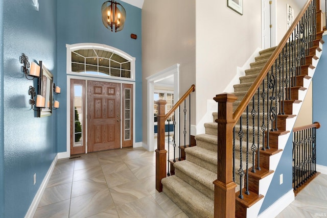 1206 Phaeton Way, Auburn, IN 46706 - entrance foyer with baseboards, a chandelier, a high ceiling, and stairway