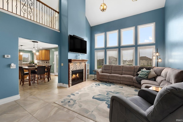1206 Phaeton Way, Auburn, IN 46706 - living area with baseboards, a fireplace, and a towering ceiling