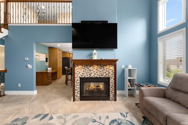 1206 Phaeton Way, Auburn, IN 46706 - living area with baseboards, a high ceiling, and a tile fireplace