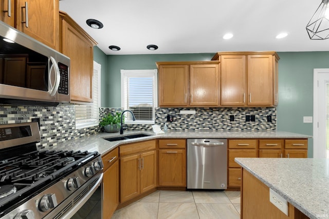 1206 Phaeton Way, Auburn, IN 46706 - kitchen with light stone counters, a sink, stainless steel appliances, light tile patterned floors, and backsplash