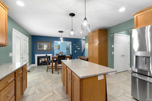 1206 Phaeton Way, Auburn, IN 46706 - kitchen featuring stainless steel refrigerator with ice dispenser, light stone counters, hanging light fixtures, and a center island