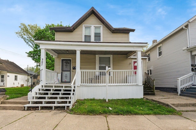 view of front of house featuring covered porch and stairway