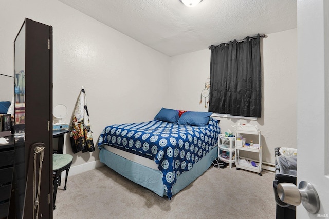 bedroom with a textured ceiling and carpet
