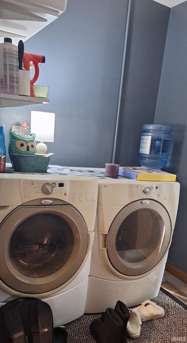 washroom with separate washer and dryer and laundry area