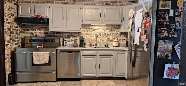 kitchen with exhaust hood, a sink, light countertops, stainless steel appliances, and white cabinetry