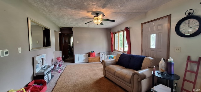 carpeted living room with a ceiling fan and a textured ceiling