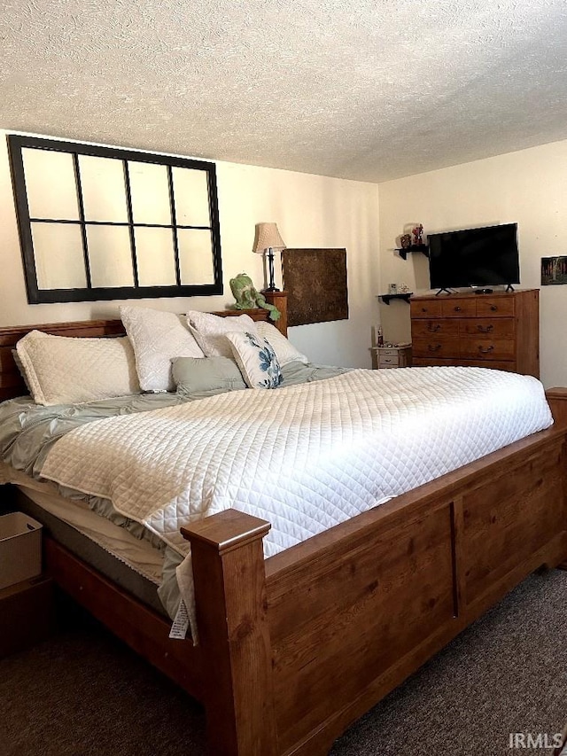 carpeted bedroom featuring a textured ceiling