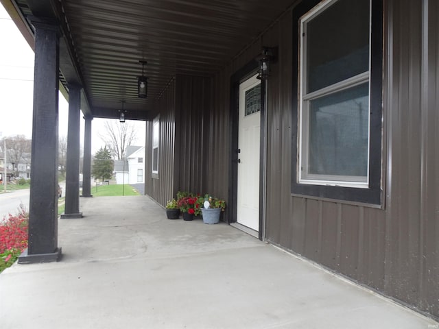 view of patio / terrace with a carport and a porch