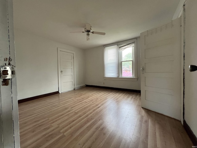unfurnished bedroom featuring baseboards, ceiling fan, and wood finished floors