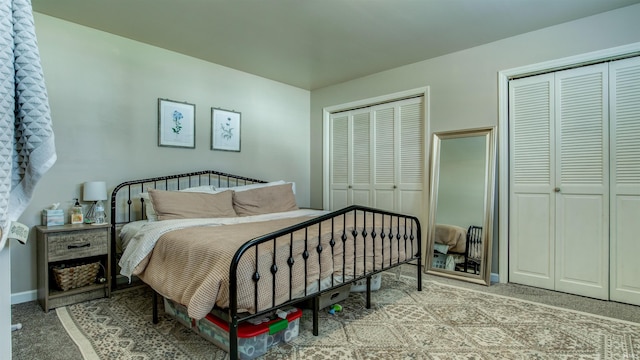 carpeted bedroom with baseboards and multiple closets