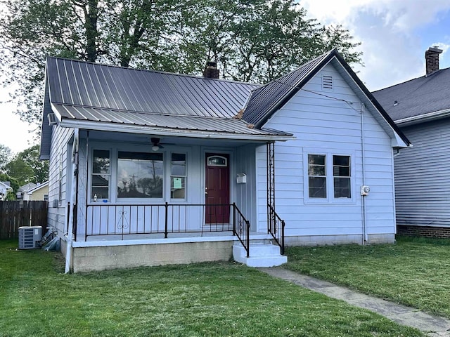 1045 13th St, Tell City, IN 47568 - bungalow-style home with a front lawn, a chimney, cooling unit, a ceiling fan, and covered porch