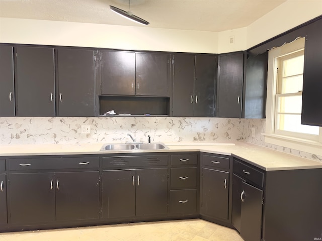 1045 13th St, Tell City, IN 47568 - kitchen featuring light countertops, backsplash, and a sink