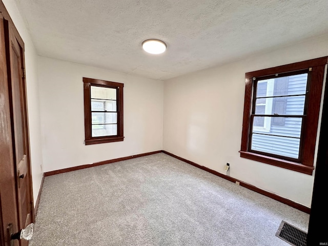 1045 13th St, Tell City, IN 47568 - unfurnished bedroom with baseboards, carpet flooring, a textured ceiling, and visible vents