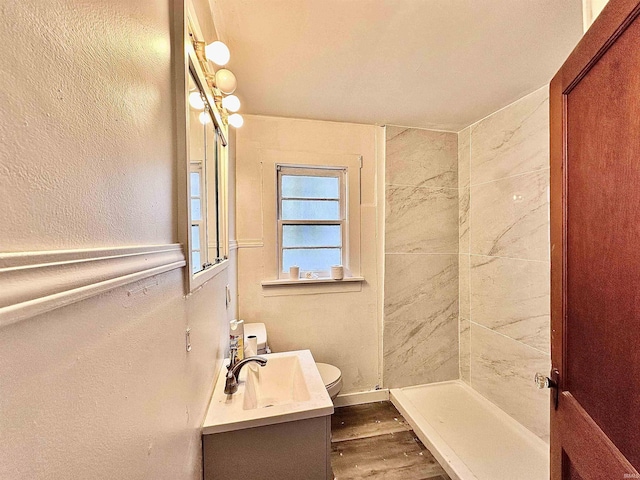 1045 13th St, Tell City, IN 47568 - bathroom with a shower, wood finished floors, vanity, toilet, and a textured wall