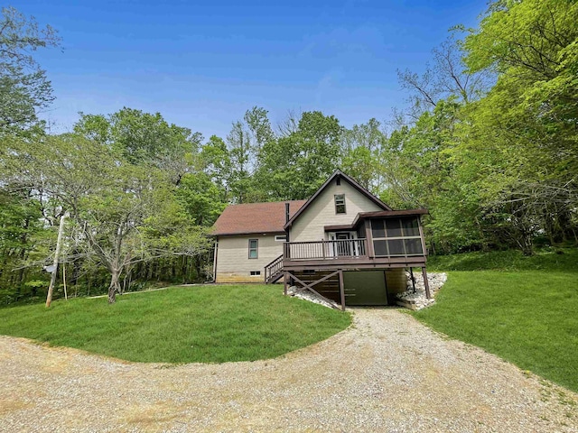 4970 S 700 W, Owensville, IN 47665 - view of front of house featuring a sunroom, driveway, a front lawn, a garage, and a carport