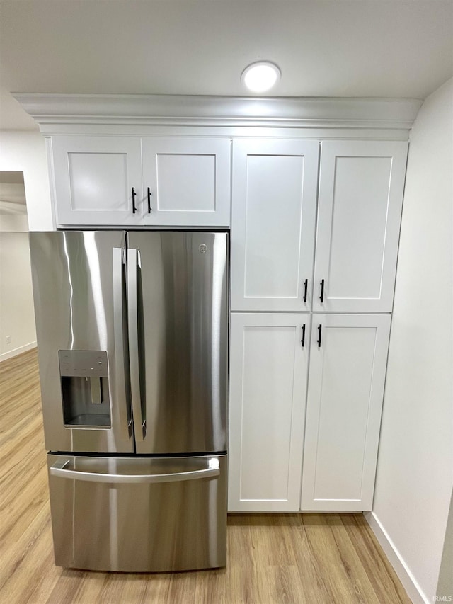 4970 S 700 W, Owensville, IN 47665 - kitchen view of stainless steel fridge, light wood-style floors, white cabinets, and baseboards