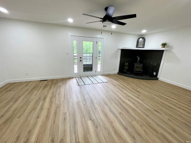 4970 S 700 W, Owensville, IN 47665 - unfurnished living room featuring a wood stove, baseboards, wood finished floors, recessed lighting, and ceiling fan
