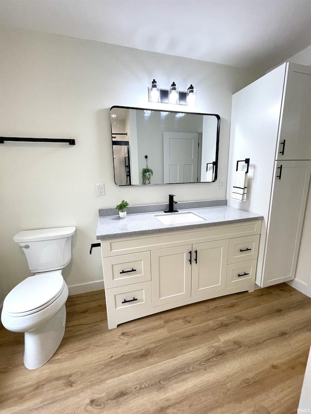 4970 S 700 W, Owensville, IN 47665 - bathroom featuring baseboards, wood finished floors, toilet, and vanity