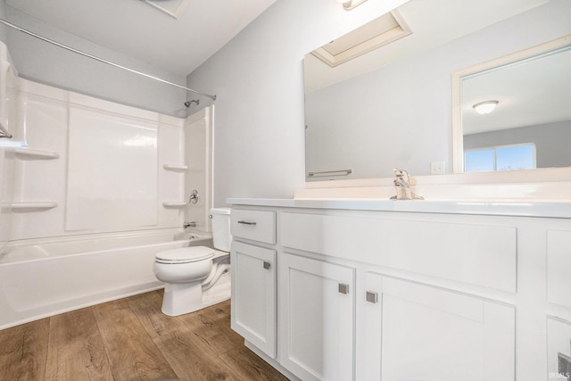 full bathroom featuring vanity, toilet, wood finished floors, and shower / washtub combination