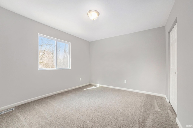 carpeted empty room with baseboards and visible vents