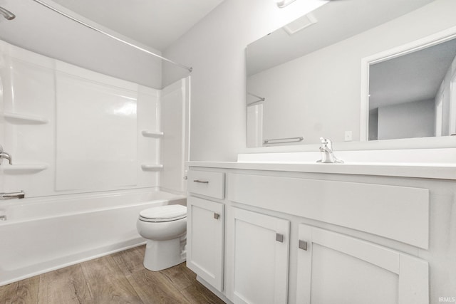 full bath with vanity,  shower combination, wood finished floors, and toilet