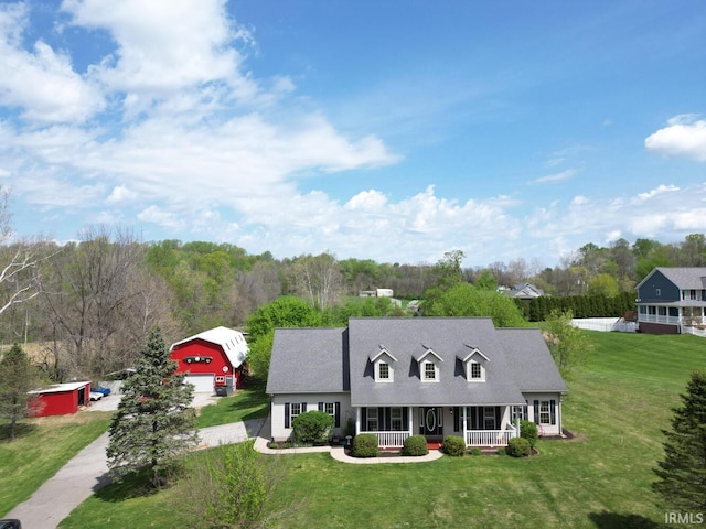 cape cod house featuring a porch and a front lawn