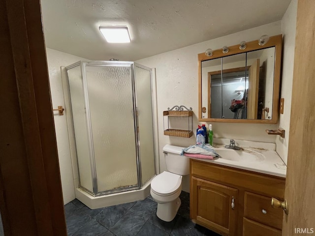 bathroom with vanity, tile patterned floors, a shower stall, and toilet