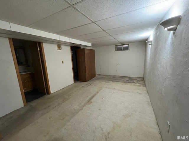 finished below grade area featuring a paneled ceiling