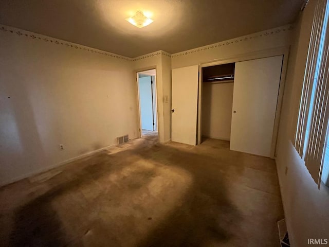 unfurnished bedroom with a closet and visible vents