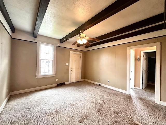 1037 14th St, Tell City, IN 47568 - unfurnished bedroom featuring baseboards, beam ceiling, and carpet