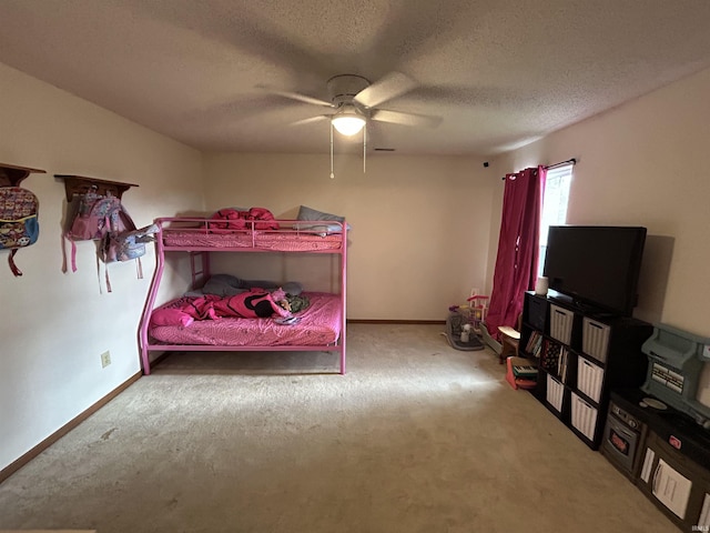 bedroom with a textured ceiling, baseboards, a ceiling fan, and carpet