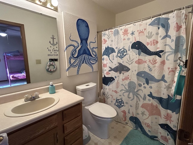 bathroom featuring toilet, a shower with curtain, and vanity